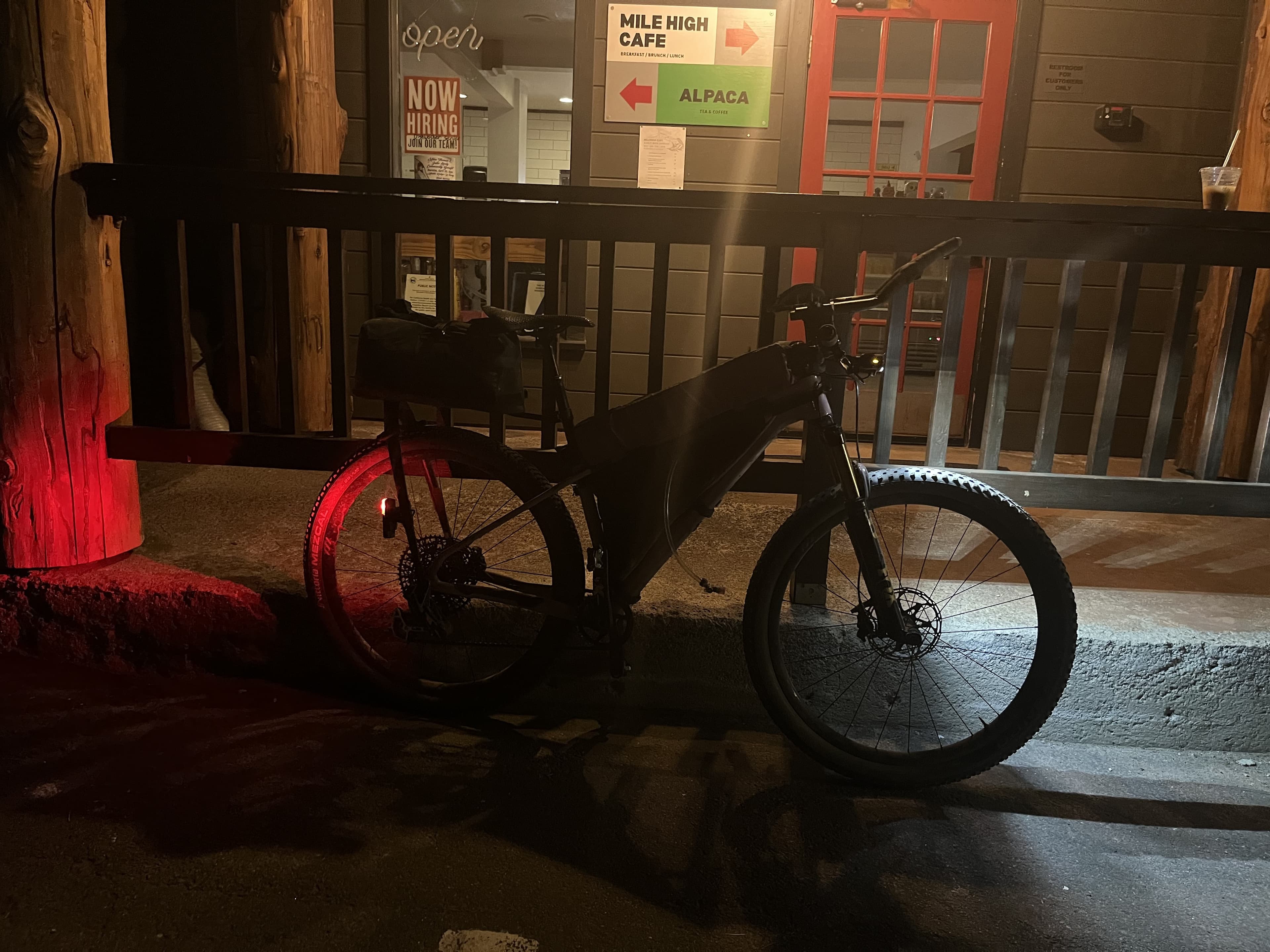 Bike leaned against a railing outside the Mile High Cafe in Idyllwild at night, finish complete